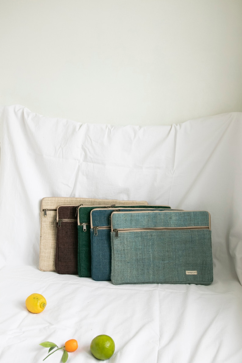 Eco-friendly hemp laptop sleeve in natural beige, blue, pink, green and light blue, designed to fit 13-inch and 15-inch laptops. Features a minimalist, sustainable design with two spacious compartments for accessories.