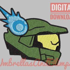 以下が含まれることがあります： ハロービデオゲームシリーズのマスターチーフのヘルメットの刺繍デザイン。緑と黄色のデザインで、ヘルメットの上部から青いエネルギーの爆発が出ている。