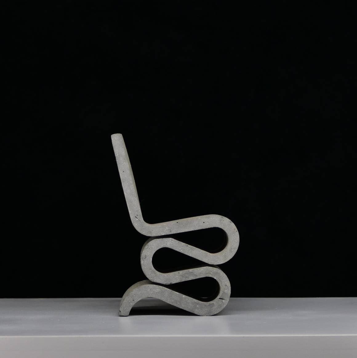 Concrete look sculpture, wiggle chair sculpture