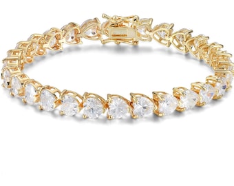 Può includere: Un braccialetto da tennis color oro con una fila di pietre di zircone cubico trasparenti a forma di cuore.