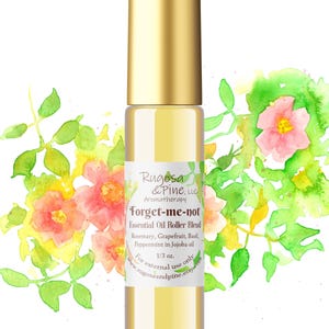 May include: A glass roller bottle with a gold lid and label. The label reads "Rugosa & Pine, LLC Aromatherapy Forget-me-not Essential Oil Roller Blend Rosemary, Grapefruit, Basil, Peppermint in Jojoba oil 1/3 oz. For external use only www.rugosaandpine.etsy.com". The bottle is surrounded by a watercolor illustration of pink flowers and green leaves.