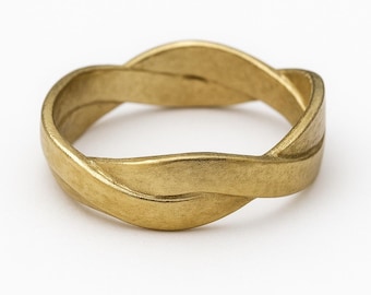 May include: A gold-toned ring featuring a continuous, flowing twisted band design. The metal surface has a matte, slightly textured finish that catches the light along the curves of the band, creating a subtle interplay of shadow and highlights.