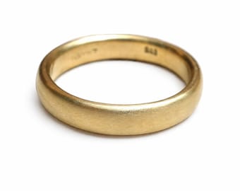 May include: A solid gold band ring with a brushed matte finish. The interior of the ring features visible hallmarks and the number 585 stamped into the metal surface. The ring has a rounded profile and a consistent width throughout its circumference.