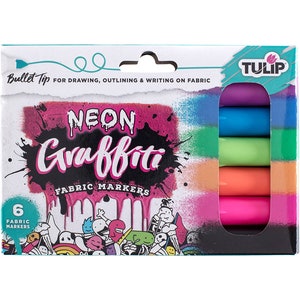 May include: A package of 6 Tulip Neon Graffiti Fabric Markers. The markers have a bullet tip and are ideal for drawing, outlining, and writing on fabric. The package is white with a black and pink design and features the text "Neon Graffiti Fabric Markers".