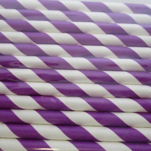 May include: A close-up of a bundle of purple and white striped paper straws. The straws are arranged in a diagonal pattern.