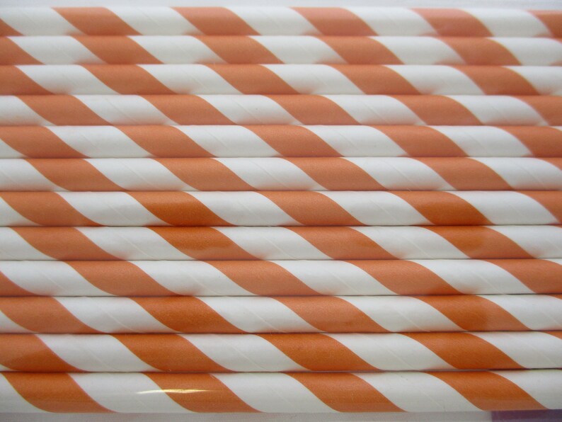 May include: A bundle of orange and white striped paper straws.