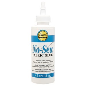 May include: A 4-ounce bottle of Aleene's Original No-Sew Fabric Glue. The bottle is white with a blue label and a white cap. The label says "No-Sew Fabric Glue" and includes instructions for use in English, French, and Spanish.