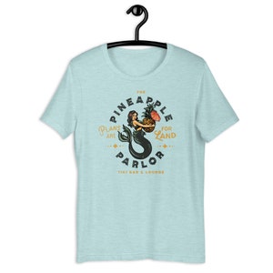 The Pineapple Parlor Tiki Bar & Lounge Short-Sleeve Unisex T-Shirt. Cute, Retro Tattoo-Style Tropical Mermaid Art Gift Idea