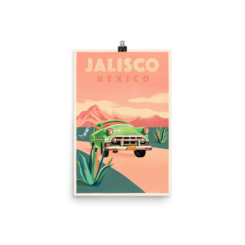 Op de afbeelding: Een vintage groene auto rijdt over een weg met agaveplanten aan beide kanten. De lucht is zacht roze en oranje. De tekst "Jalisco Mexico" staat bovenaan de afbeelding.