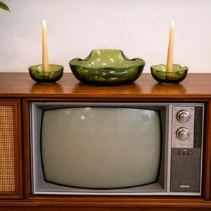 May include: A set of three ceramic mugs with a speckled, matte finish. The mugs are in shades of cream, light gray, and dark gray. Each mug has a simple, minimalist design and a rounded handle. Perfect for coffee or tea.