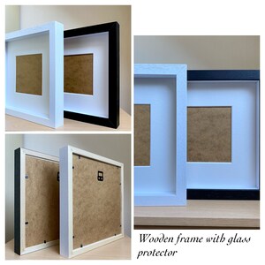 May include: Two picture frames, one white and one black, with a glass protector. The frames are made of wood and have a simple design.