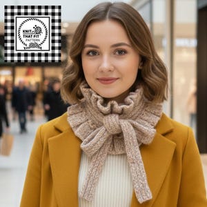 Peut inclure: Une femme porte une écharpe-cowl beige tricotée avec un bord à volants et un nœud. La femme porte un manteau jaune et un pull blanc. L'image comprend un logo qui dit "Knit That Fit Pattern" dans un cadre à carreaux noir et blanc.