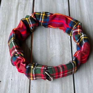 May include: Red, green, and yellow plaid dog collar with a silver buckle.