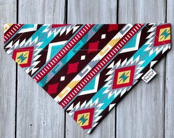 May include: A red, white, blue and yellow geometric patterned dog bandana with a "Doggers Boutique" label.