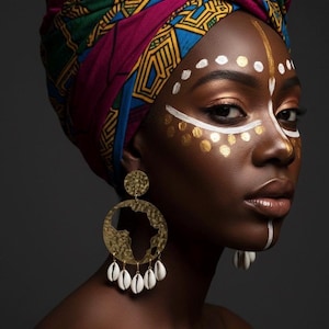 May include: A person with dark skin is depicted wearing a vibrant patterned headscarf. They have gold and white face paint and large gold earrings featuring an African continent design and dangling white shells.