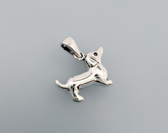 May include: Silver dachshund charm pendant. The charm is detailed and has a shiny finish.