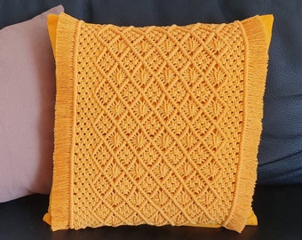 Decorative bohemian cushion in mustard yellow macramé