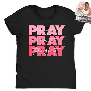 May include: Black t-shirt with the words "Pray on it, Pray over it, Pray through it" in pink lettering.