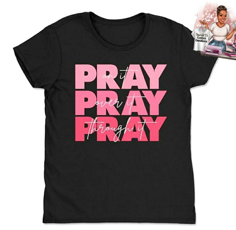 May include: Black t-shirt with the words "Pray on it, Pray over it, Pray through it" in pink lettering.