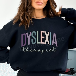 May include: Black sweatshirt with the text "Dyslexia therapist" in a rainbow of colors.