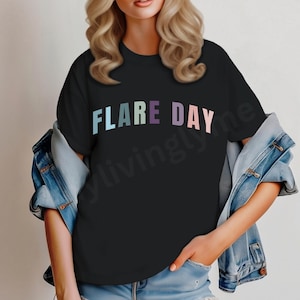 May include: A black t-shirt with the text "FLARE DAY" in rainbow colors.