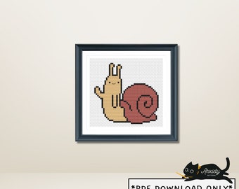 May include: A framed cross-stitch art piece featuring a smiling snail with a light brown body and a reddish-brown shell. The snail is waving. The text "*PDF DOWNLOAD ONLY*" is at the bottom.