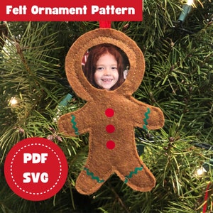 May include: A felt gingerbread man ornament with a circular opening for a photo. The ornament is brown with green zig-zag trim and red buttons. The text "PDF SVG" is on a red circle with a dashed border.