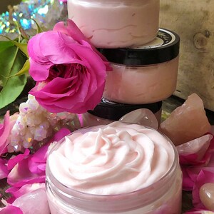 May include: Three jars of pink whipped body butter with a pink rose and rose petals surrounding them.