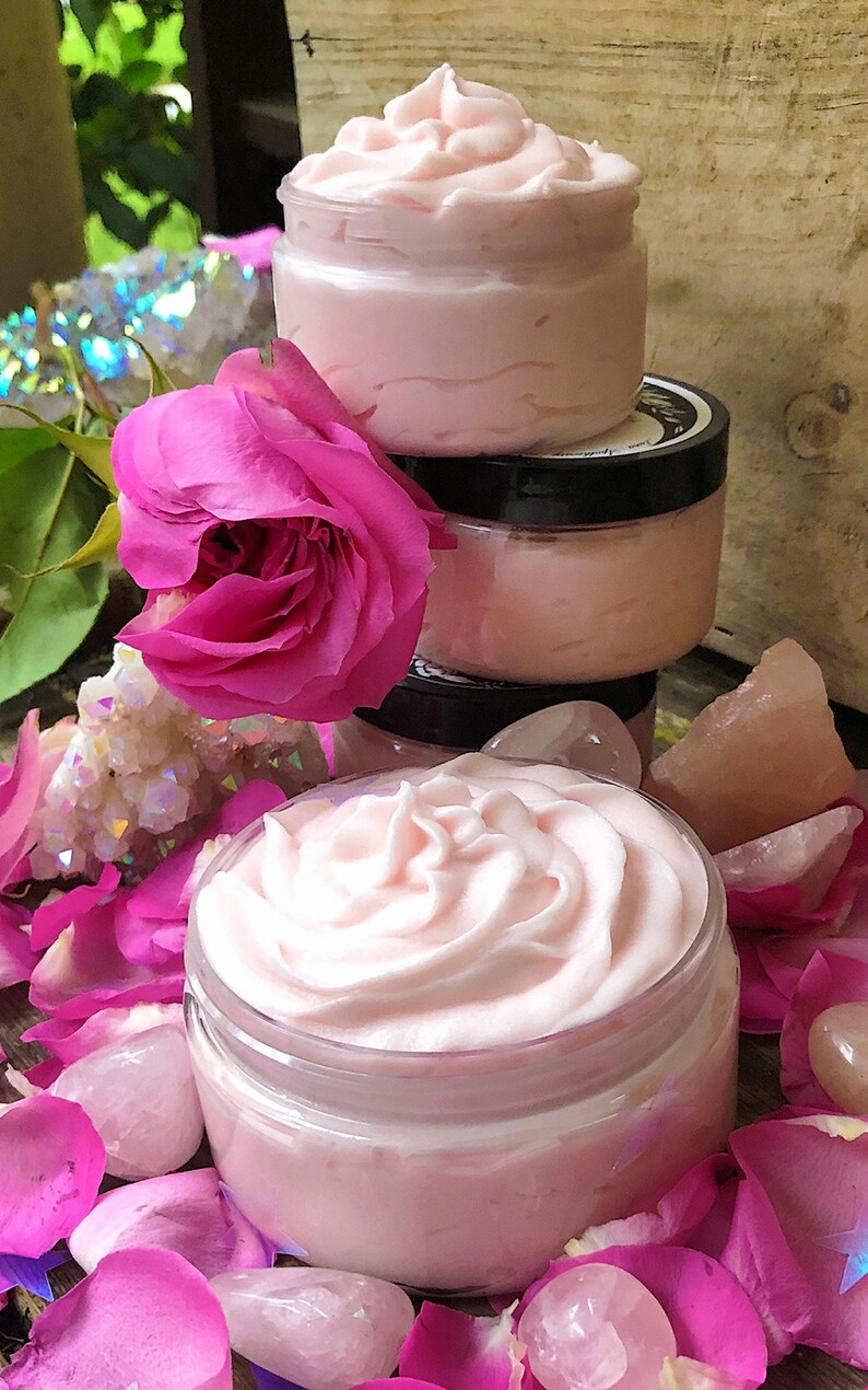 May include: Three jars of pink whipped body butter with a pink rose and rose petals surrounding them.