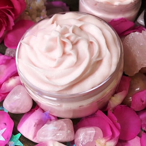 May include: Two jars of pink whipped body butter with a swirl design, surrounded by pink rose petals and rose quartz crystals.