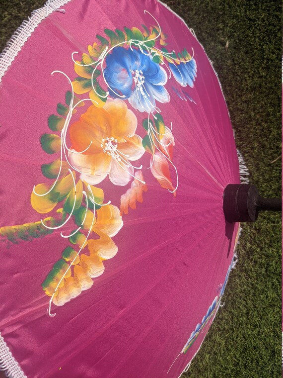 Compact pink parasol with tassels and brightly pa… - image 4