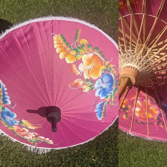 Compact pink parasol with tassels and brightly pa… - image 1
