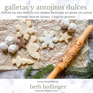 May include: A close-up of a wooden rolling pin with a carved design of holly leaves and berries. The rolling pin is lying on a piece of brown parchment paper with a variety of cookies and sugar cookies in the shape of snowflakes, stars, and trees. The text "galletas y antojitos dulces" is written in green at the top of the image.