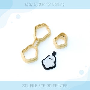 May include: A 3D printed clay cutter for earrings in the shape of a ghost. The cutter is beige and the ghost is white with black eyes. The text "Clay Cutter for Earring" and "STL FILE FOR 3D PRINTER" are visible in the image.