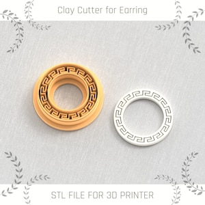 May include: Two 3D printed clay cutters for earrings. The larger cutter is brown and has a double-layered Greek key design. The smaller cutter is white and has a single-layered Greek key design.