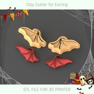 May include: A set of four 3D printed clay cutters for earrings. The cutters are shaped like bat wings, two are beige and two are red.