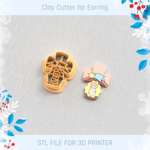 May include: A clay cutter for earrings and a finished earring. The cutter is light orange and shaped like a cross with a baby Jesus design. The finished earring is a cross with a star and baby Jesus design. The text "STL FILE FOR 3D PRINTER" is at the bottom.
