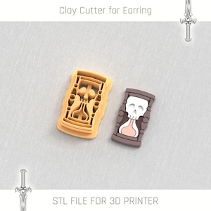 May include: Two 3D printed clay cutters for earrings. One cutter is shaped like an hourglass with a skull design. The other cutter is a more intricate design with a skull inside a frame.