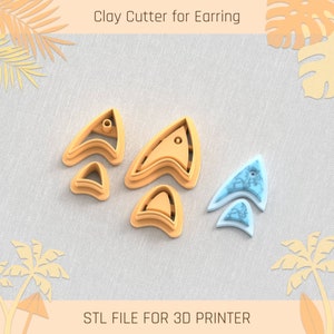 May include: A set of five clay cutters for earrings, shaped like a stylized arrow. The cutters are made of a light brown plastic and are designed to be used with polymer clay. The cutters are arranged in a row on a light gray surface. The image also includes the text "STL FILE FOR 3D PRINTER".