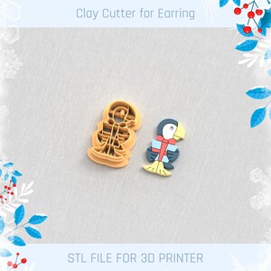 May include: Two clay cutters for earrings. One is a tan skeleton shape, and the other is a colorful penguin holding a gift. The text "Clay Cutter for Earring" and "STL FILE FOR 3D PRINTER" are at the top and bottom of the image.