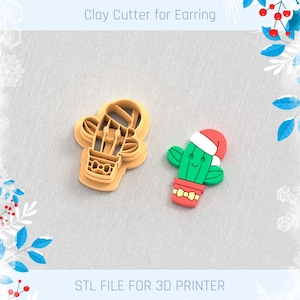 May include: A clay cutter and a finished earring in the shape of a cactus. The cutter is tan, and the earring is green with a red pot and Santa hat. Text at the top says "Clay Cutter for Earring" and at the bottom "STL FILE FOR 3D PRINTER".