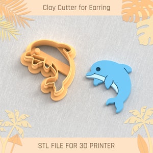 May include: A 3D printed clay cutter for earrings shaped like a dolphin. The cutter is orange and the dolphin is blue. The text "Clay Cutter for Earring" and "STL FILE FOR 3D PRINTER" are visible in the image.