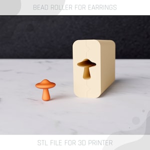 May include: A 3D printable STL file for a bead roller, shaped like a mushroom. The roller is beige and has a mushroom-shaped cutout. A small, orange mushroom-shaped bead is shown next to the roller.