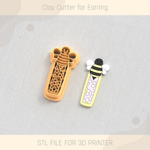 May include: Two 3D printed cookie cutters shaped like a bee. The bee on the left has a honeycomb pattern and the bee on the right has a daisy pattern. The text "Clay Cutter for Earring" is at the top of the image and the text "STL FILE FOR 3D PRINTER" is at the bottom of the image.