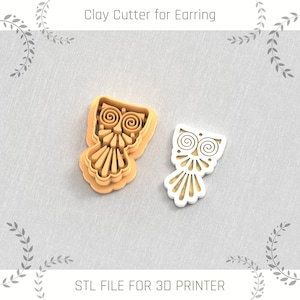 May include: A 3D printed owl-shaped clay cutter for earrings. The cutter is shown in two parts, one in brown and one in white. The text "STL FILE FOR 3D PRINTER" is at the bottom of the image.