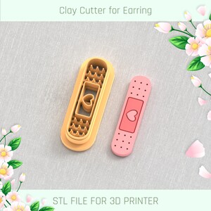 May include: A 3D printable STL file for a clay cutter shaped like a bandage with a heart. The cutter is designed for making earrings.
