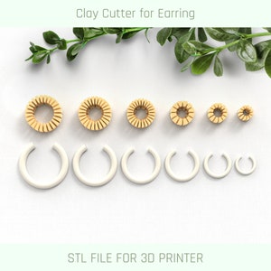 May include: Set of seven clay cutters for earrings, in various sizes. The cutters are made of a light brown plastic and are arranged in a row from largest to smallest. The cutters are designed to create a variety of earring shapes. STL FILE FOR 3D PRINTER.