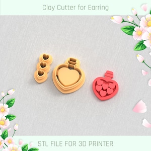 May include: Three 3D printed clay cutters for earrings. The cutters are shaped like hearts and a bottle filled with hearts. The cutters are made for a 3D printer and are labelled "STL FILE FOR 3D PRINTER".
