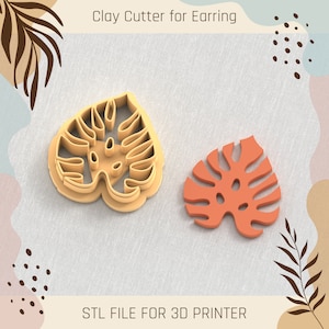 May include: Two 3D printed clay cutters shaped like monstera leaves. The cutters are beige and orange. The text "Clay Cutter for Earring" and "STL FILE FOR 3D PRINTER" are visible in the image.