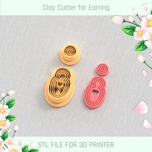 May include: Two sets of clay cutters for earrings, one in pink and one in orange, with a heart shape in the centre. The cutters are designed to be used with a 3D printer. The text "STL FILE FOR 3D PRINTER" is at the bottom of the image.